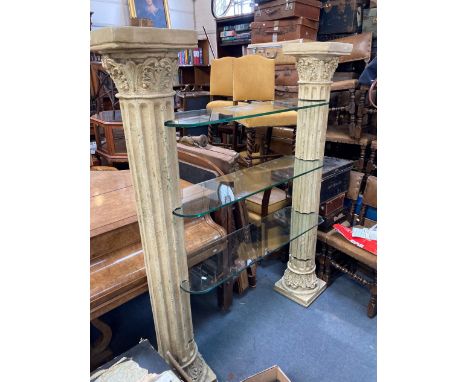 A TWIN-PILLAR DISPLAY STAND with four plate glass shelves supported between two patinated fibreglass fluted columns approx. 1