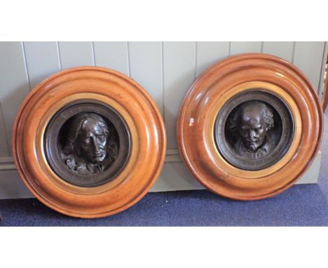 A PAIR OF 19TH CENTURY BRONZED RELIEF ROUNDELS, SHAKESPERE AND BUNYAN (?) by R. Jefferson, in substantial turned golden oak f