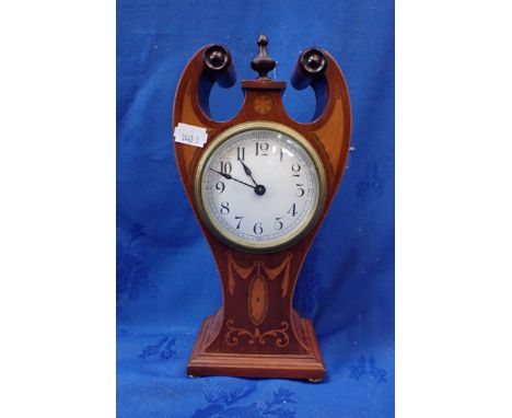 AN EDWARDIAN INLAID MAHOGANY CLOCK (TIMEPIECE) of slender proportions, with scrolling top, and finial (working) 28 cm high 