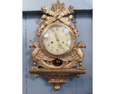 A SWEDISH EMPIRE STYLE CARTEL CLOCK, IN CARVED GILTWOOD CASE striking on a bell 54cm high (working)