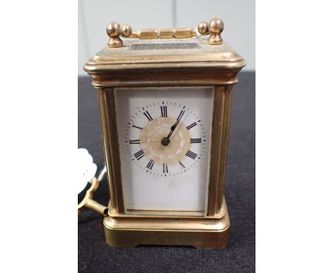 A MINIATURE BRASS-CASED CARRIAGE CLOCK 7cm high (plus handle)