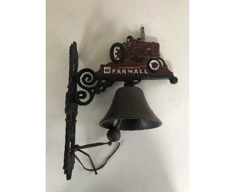 A cast metal bell on wall bracket - Tractor