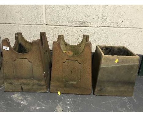 Three chimney pots together with a terracotta planter 