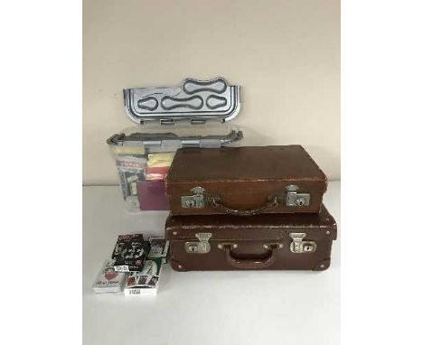 A box containing a large quantity of playing cards, together with two small leather suitcases
