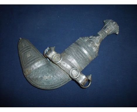 Omani Jambiya, the hilt and scabbard covered overall with Eastern silver with a fine wire geometric design, with a 6 1/2 inch