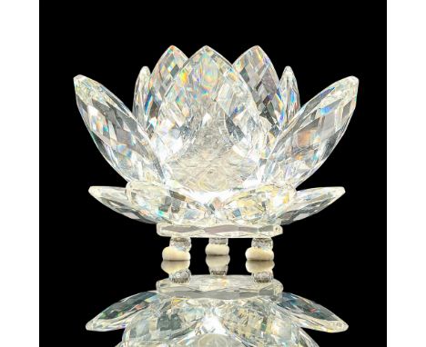 Large crystal water lily with faceted petals, center opening for a candlestick, and spherical feet applied to base. Swarovski