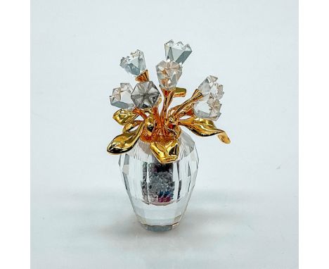 Multifaceted clear crystal vase with 7 clear crystal flowers on gold tone stems. Vase is full of tiny multicolored crystals. 