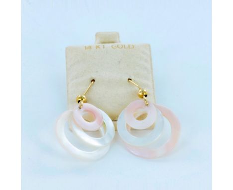 14k gold earrings with dangling mother of pearl rings. Dimensions: 1.5"L x 1"WCondition: Age related wear.
