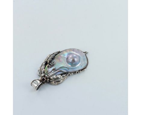 Strikingly beautiful piece with an iridescent shell in a free form surrounded by sterling silver leaves and scrolling vines. 