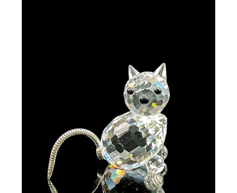 Clear faceted crystal figure of a seated cat with black nose and eyes, flexible metal tail. Item number 7659NR031000. Part of