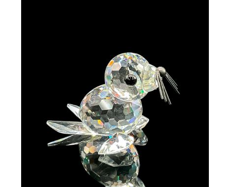 Clear faceted crystal figure of a seal with black eyes, nose and metal whiskers. Part of the Kingdom of Ice and Snow collecti