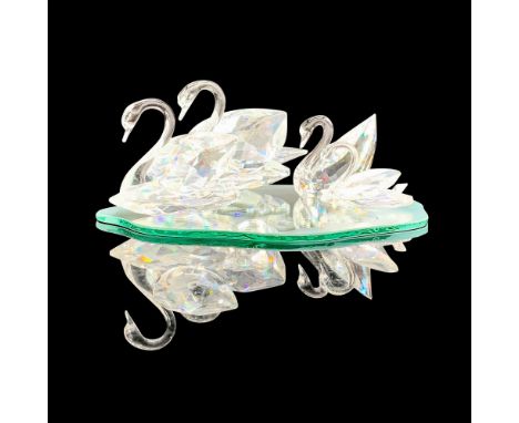 A set of 4 beautiful clear crystal Swarovski swans, 5215947, 15152, 10006, and 10005 that includes a reflective lake shaped b