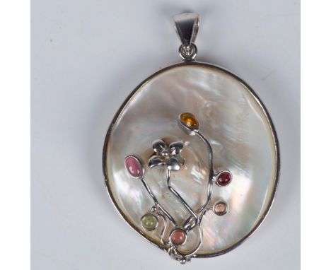 Mother of pearl pendant with sterling silver floral design accented by small multicolor stones. 925 stamped on bale. Dimensio