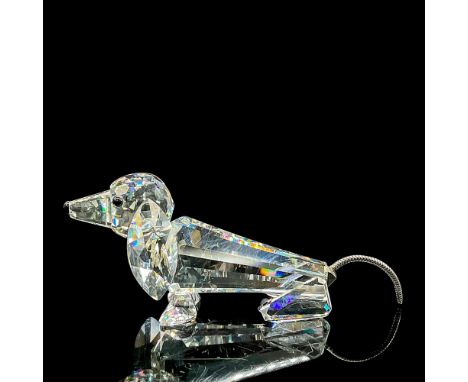 Clear faceted crystal figure of a dog with wire tail, black eyes and nose. Item number 7641NR075000. Swarovski etched mark. T