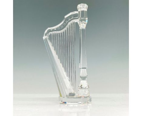 A sparkling faceted crystal figurine modeled as a pedal harp. Swarovski acid mark to base. Original box included. Box dimensi