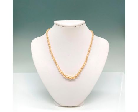 Faux golden pearl strand with a silver tone box tab clasp. Dimensions: 17"LCondition: Age related wear.