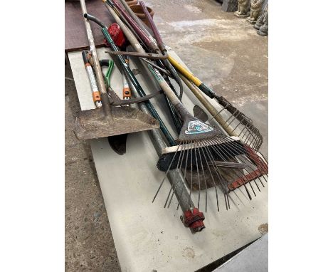 Mixed lot of garden tools to include spades, rakes, brushes etc