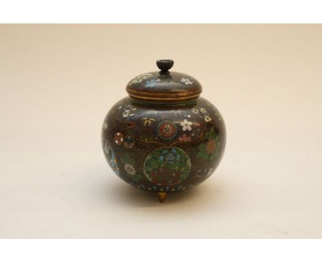 A fine quality Japanese Cloisonne jar and cover of bulbous form having reserves decorated with animals and symbols, on tripod