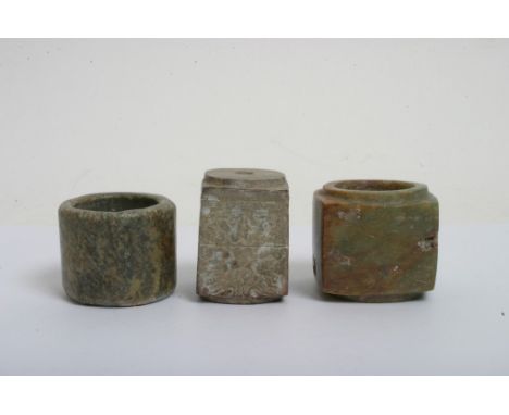 A Chinese green hardstone Cong of archaic design, possible Jade, together with one other stone Cong and a carved stone cylind