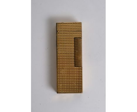A gold tone Dunhill lighter