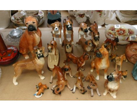 An extensive collection of assorted ceramic figures of Boxer dogs including one by Goebel