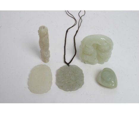 A collection of five jade carvings including three pendants, carved with figures, flowers and foliage 