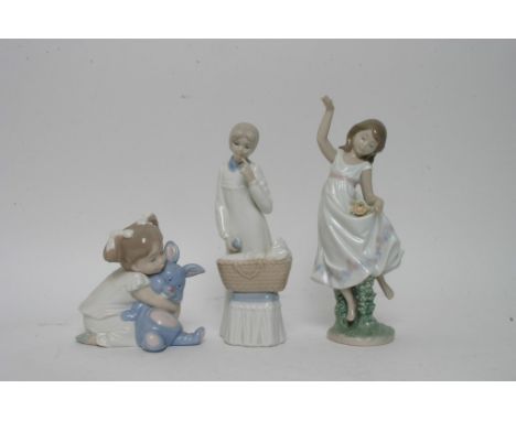 A Lladro figure of a girl, a Nao model of a young girl with a rabbit and one other figure