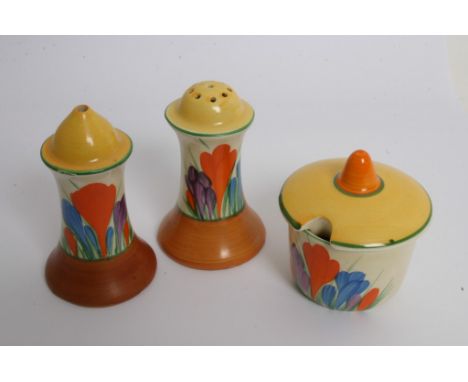A Clarice Cliff condiment set in 'Crocus' pattern consisting of salt, pepper and mustard pot. 