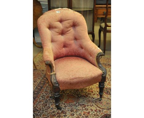 An early Victorian button back chair on casters
