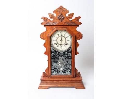 An Ansonia American mantel clock, the circular dial with roman numerals and visible pendulum 