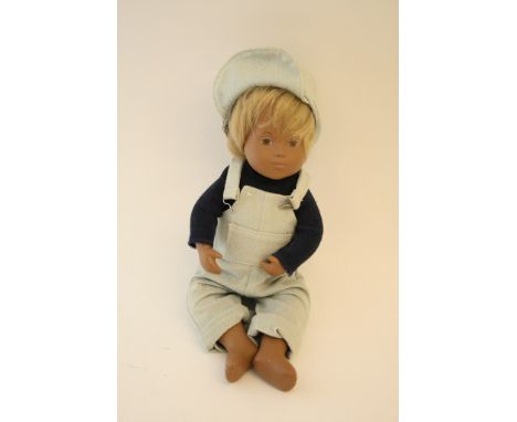 A Gotz Sasha baby doll Max, wearing blue dungarees, woollen dark jumper and hat. Comes in tube with leaflet.  Condition Repor