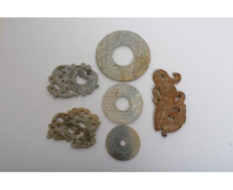 A collection of six Chinese hard stone carvings of various archaic designs including Bi discs, some possibly jade