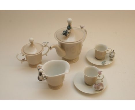 A boxed Lladro teaset comprising coffee pot, jug, covered sugar bowl and two cups and saucers, all applied with different ani