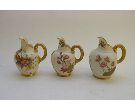 Three Royal Worcester blush ivory jugs with painted and gilded floral decoration