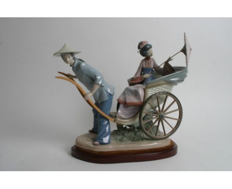 A large Lladro model 'Ride in China' of a rickshaw on wood plinth, sculpted by Salvador Debon, serial number 01001383. Approx