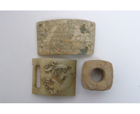 A collection of Chinese stone carvings including an archaic design cong, a green stone buckle and an archaic design stone pan