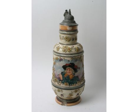 A large 19th century German stein having pewter lid and tube line decorated with a man and a pipe