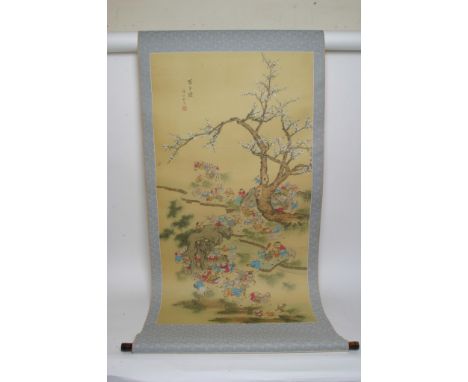 A Chinese hand painted silk hanging scroll depicting boys at play, signed and translated to Zhang Zhao Jun