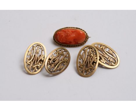 A pair of unmarked gold cufflinks and a small carved coral cameo brooch