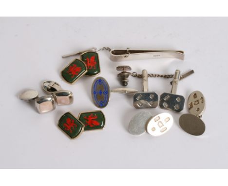 A collection of silver cufflinks and tie clips