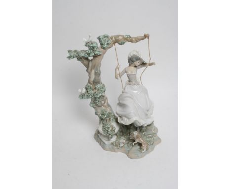 A large Lladro figure of a girl on a swing.