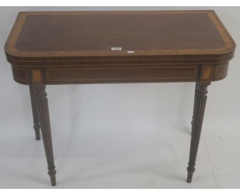 A Georgian mahogany inlaid fold over card table with column legs, 71cm high x 92cm wide x 46cm deep Condition Report: Availab