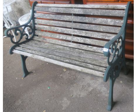 A garden bench with cast iron ends and wooden slats, 77cm high x 130cm wide x 65cm deep Condition Report: Available upon requ