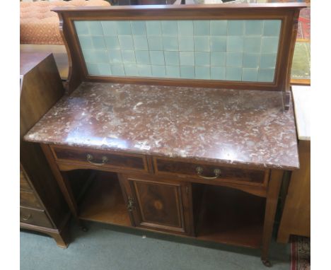 Ab Edwardian mahogany washstand with green tile back , marble top over a base with two drawers over single drawer flanked by 