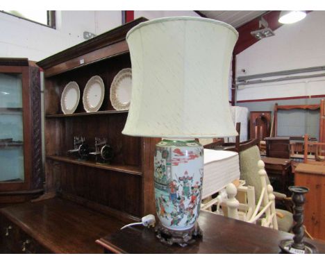 A 1930's Japanese porcelain table lamp with shade on carved wooden stand, decorated with fighters, handpainted, 50cm tall