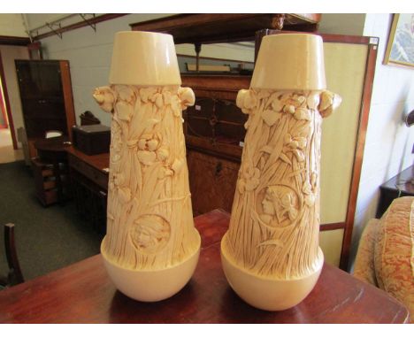 A pair of cream glazed ceramic vases with scenes of flowers and maidens, 43cm tall