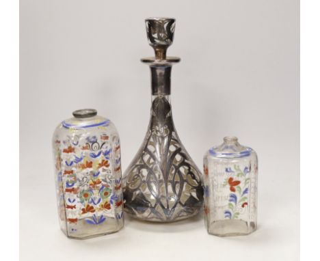 An Art Nouveau white metal jacketed decanter, together with a pair of German enamelled glass flasks, tallest 25cm (3)***CONDI