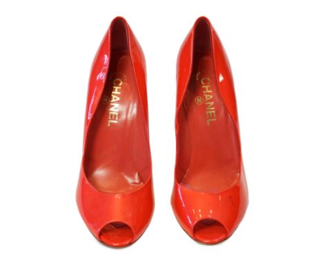 A pair of Chanel lady's metallic coral peep toe patent leather heels, with gold tone CC detail to the heel of the shoe, with 