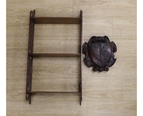 A Chippendale style open hanging shelf and an 18th/19th century carved mahogany armorial shield, shelves 80cm x 40cm***CONDIT