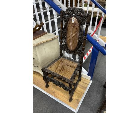 * * A Charles II carved walnut caned seat and back dining chair, c.1670, width 54cm, height 120cmPlease note this lot attract